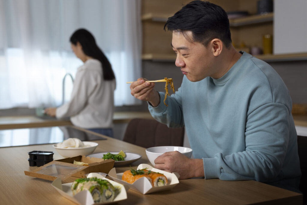 Medium shot people eating asian food