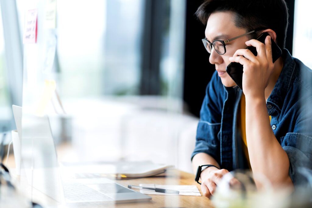 Smart attractive positive asian business male wearing glasses work remote new normal lifestyle hand use laptop tele conference onlive videocall meeting remote business ideas concept