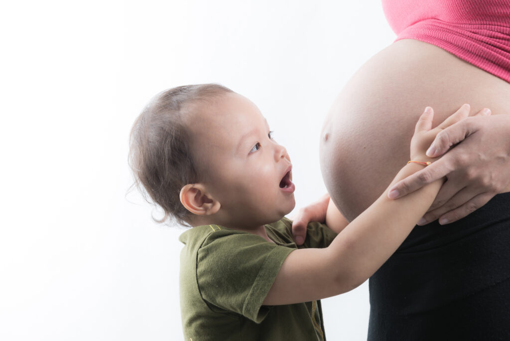 Son kiss pregnant woman