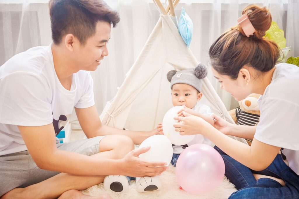 Parents playing with son while sitting home